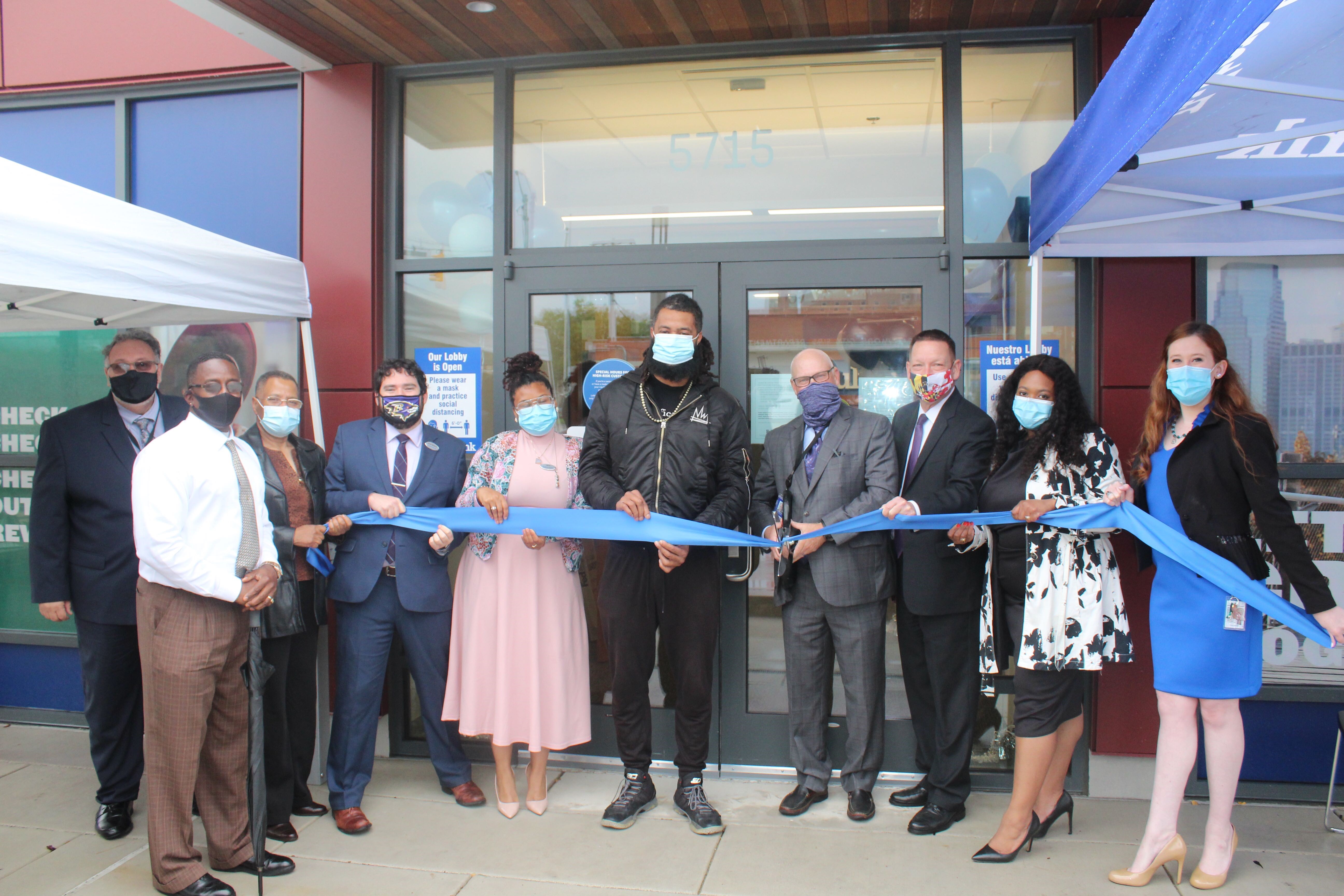 Swiftvest Bank leadership and Baltimore community members cut ribbon in front of new branch